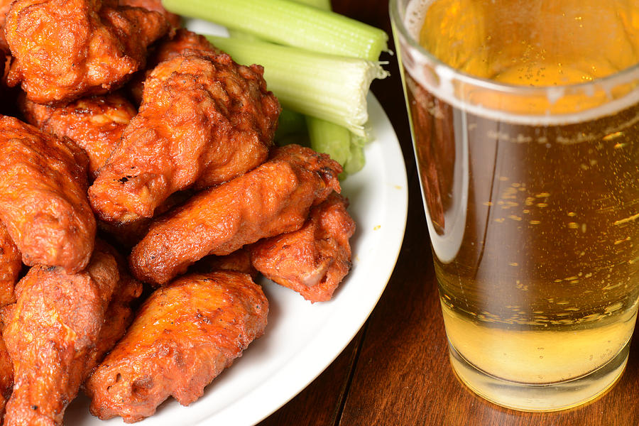Buffalo Wings with Celery Sticks and Beer Photograph by Brandon Bourdages