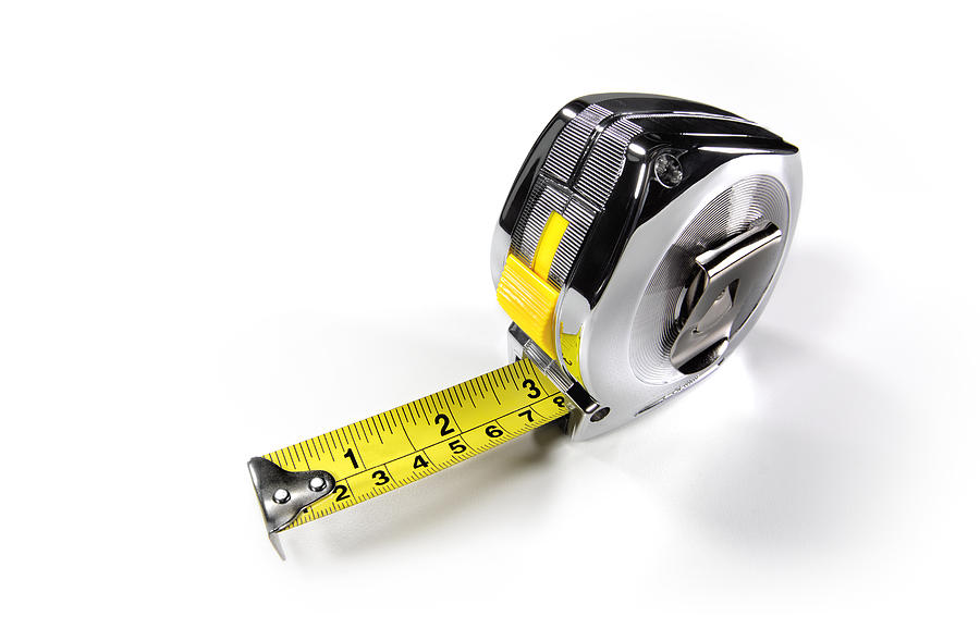 Builders metal tape measure close up Photograph by Peter Dazeley