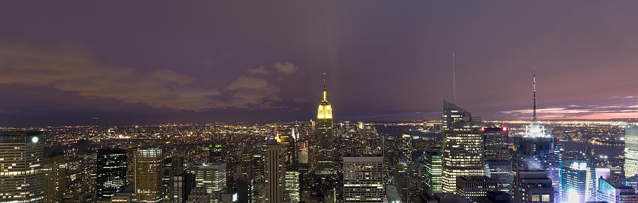 Buildings In A City Lit Up At Dusk Photograph by Panoramic Images