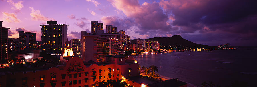 Honolulu Photograph - Buildings Lit Up At Dusk, Waikiki by Panoramic Images