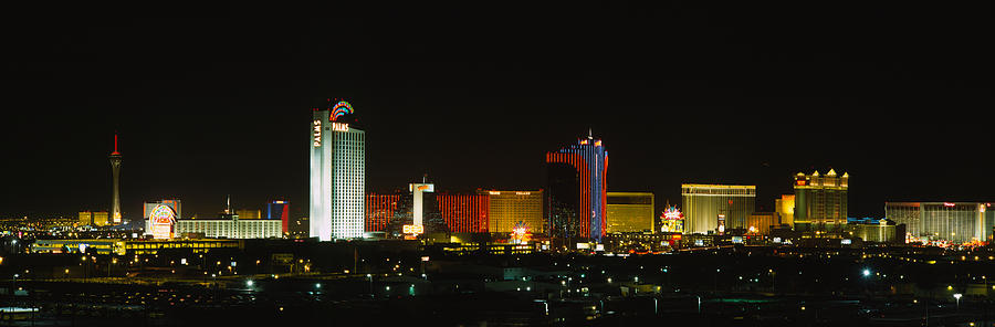 Las Vegas Photograph - Buildings Lit Up At Night In A City by Panoramic Images