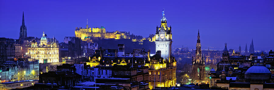 Architecture Photograph - Buildings Lit Up At Night With A Castle by Panoramic Images