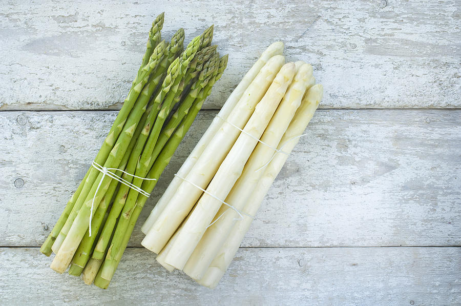 Bunches of green and white asparagus on wood Photograph by Westend61