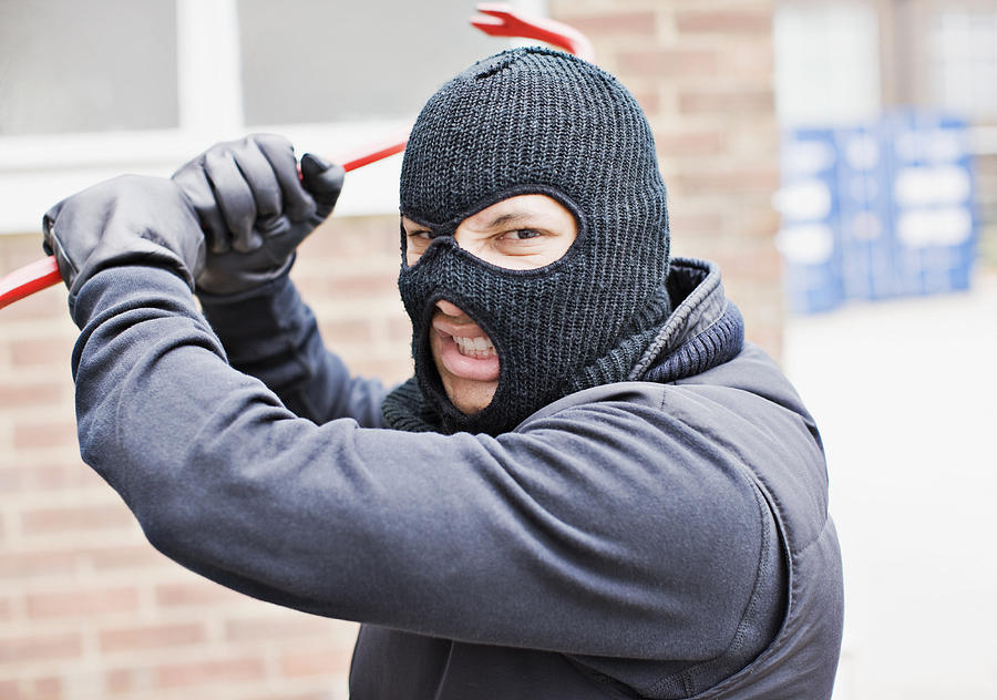 Burglar in ski mask wielding crowbar Photograph by Paul Bradbury