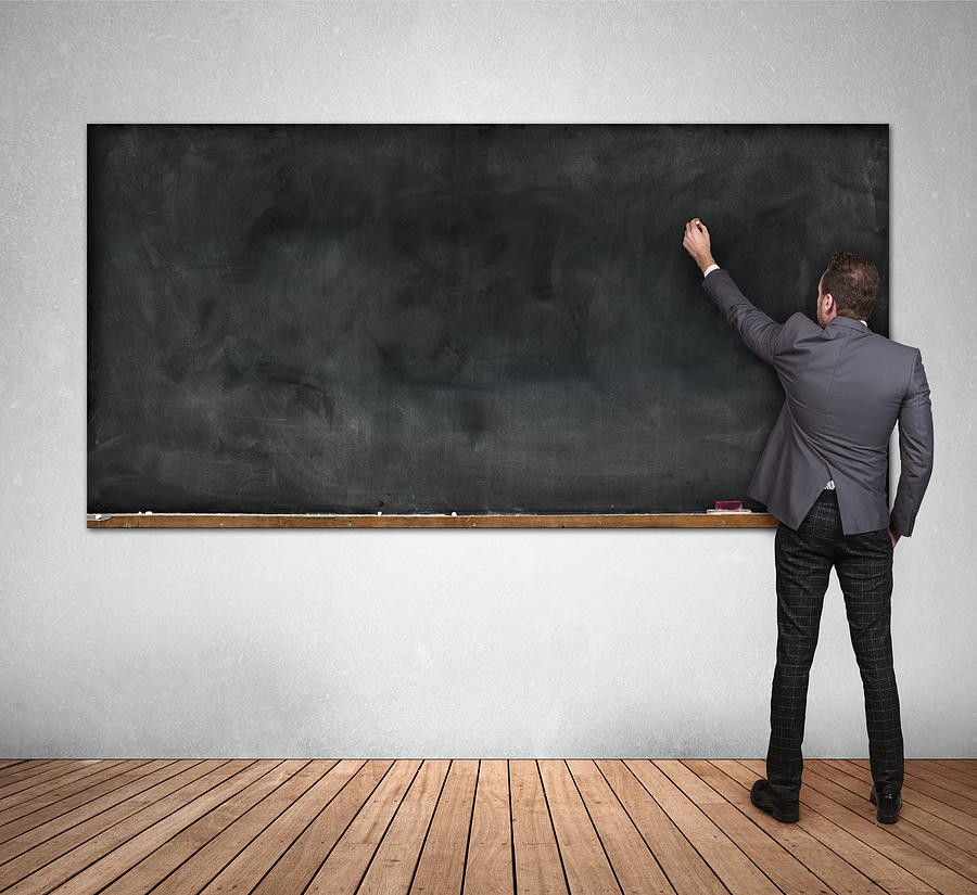 Business man written on blank blackboard Photograph by Themacx