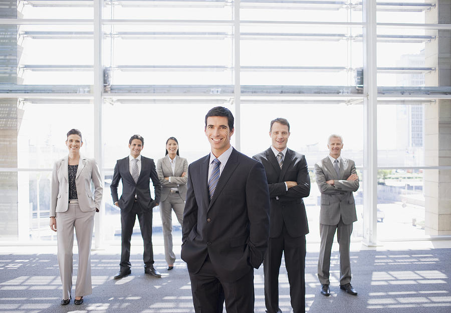 Business people standing together in office Photograph by Martin Barraud