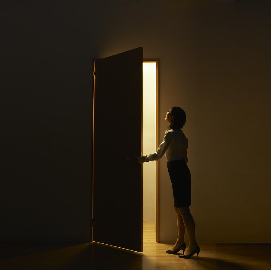 Business Woman Opening Door Standing In Light Photograph by D-base Business Woman Opening Door Standing In Light Photograph by D-base