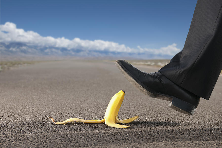 Businessman about to step on banana peel Photograph by Jacobs Stock Photography Ltd