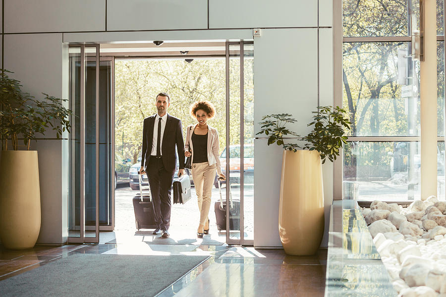 Businessman and businesswoman on business travel Photograph by Izusek