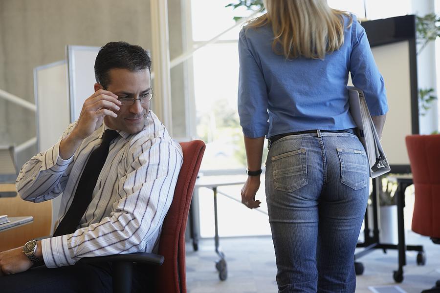 Businessman checking out female coworker Photograph by Jon Feingersh Photography Inc
