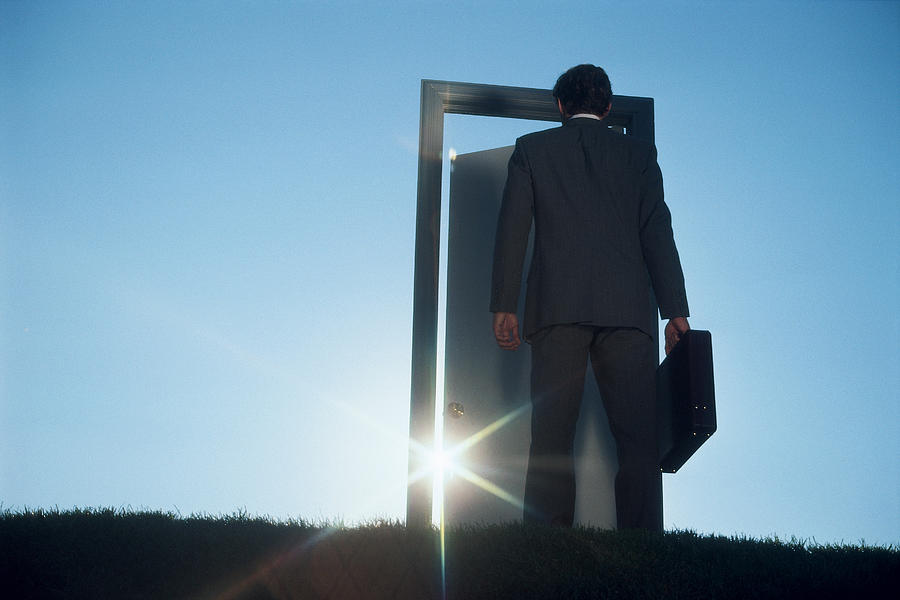 Businessman entering door outdoors Photograph by Comstock