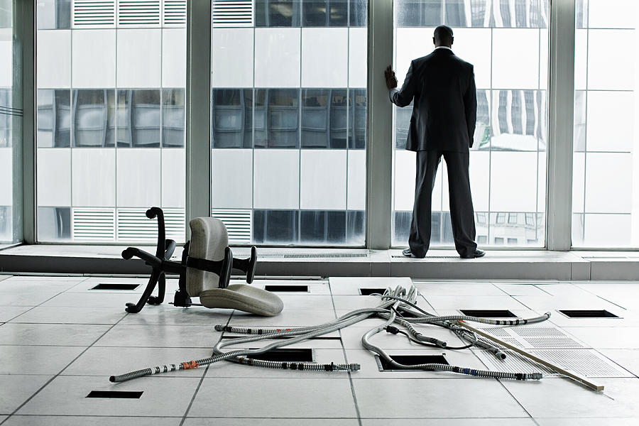 Businessman in abandoned office Photograph by Image Source