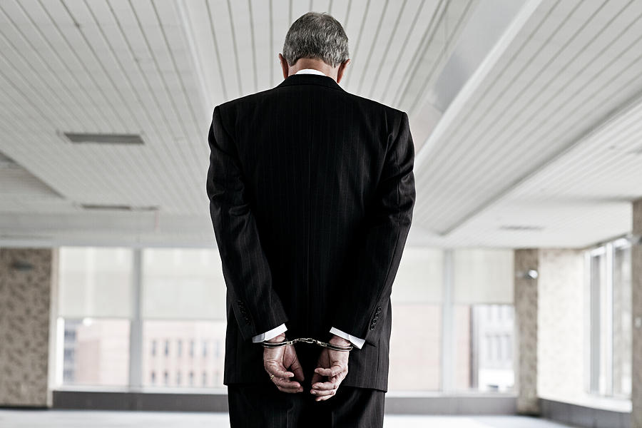 Businessman in handcuffs Photograph by Image Source