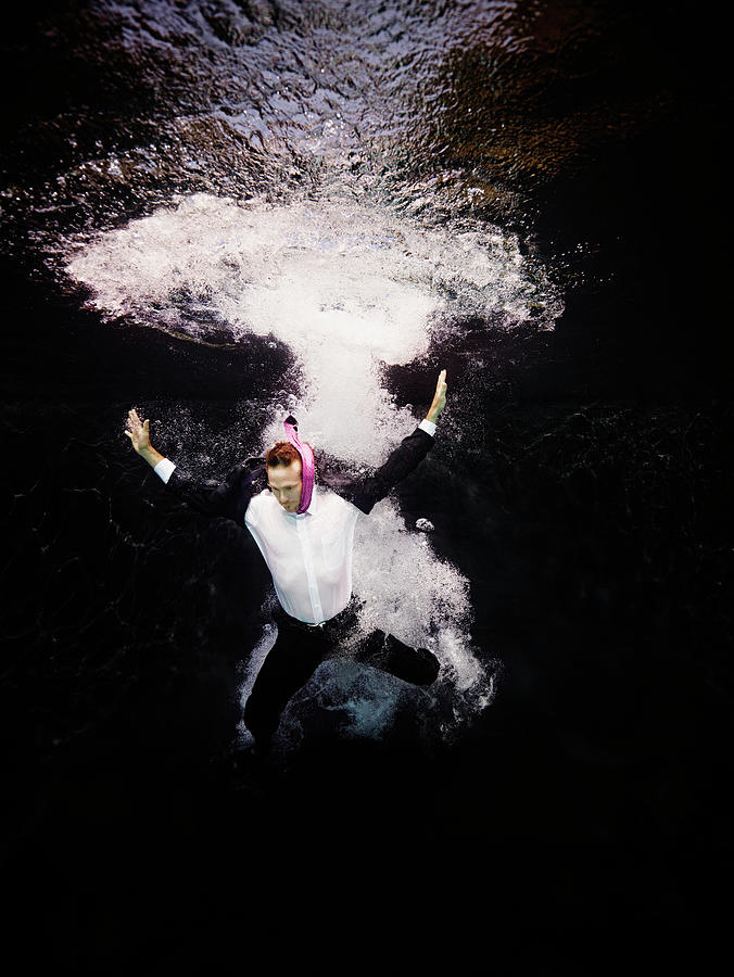 Businessman In Suit Plunging Into Water Photograph by Thomas Barwick