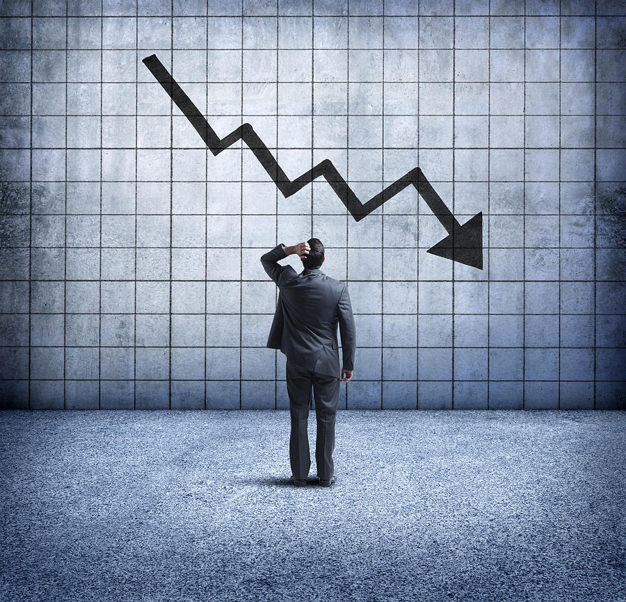 Businessman Looking Up At Downward Trending Arrow With Concern Photograph by Dny59