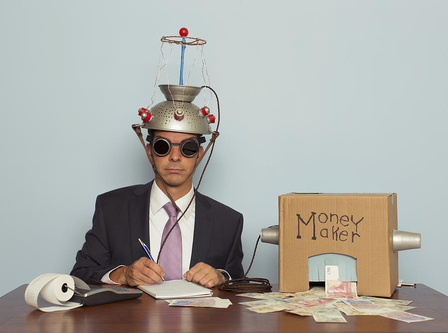 Businessman Makes Money with Helmet and Money Machine Photograph by Andrew Rich