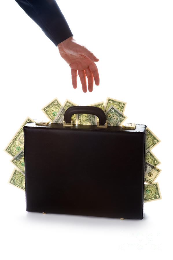 Businessman Reaching For A Briefcase Full Of Money Photograph by Lee Avison