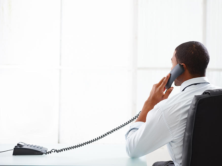 Businessman talking on the phone in his office Photograph by GlobalStock