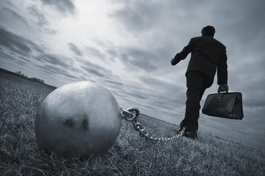 Black And White Photograph - Businessman With Ball And Chain by Don Hammond