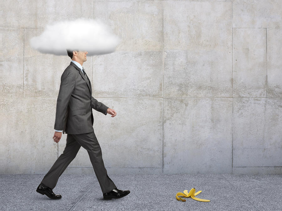 Businessman With Head In Clouds With Banana Peel In Path Photograph by Dny59