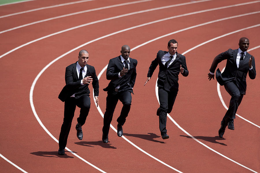 Businessmen runnin g on track Photograph by Photo and Co