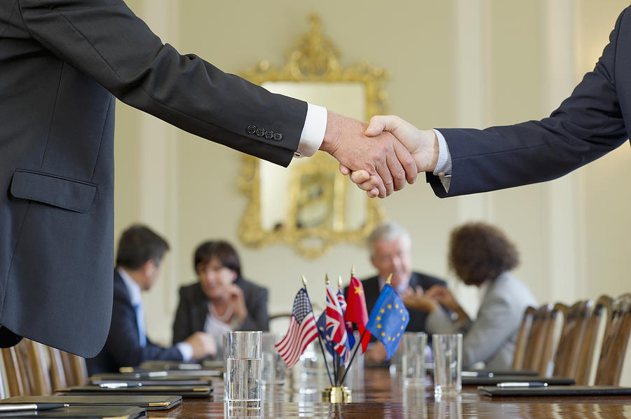 Businessmen shaking hands in meeting Photograph by Jacobs Stock Photography Ltd