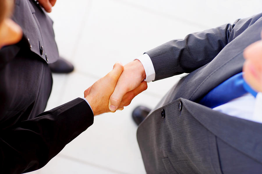 Businessmen shaking hands Photograph by Jacob Wackerhausen