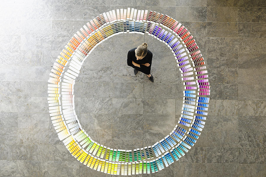 Businesswoman examining paint swatches Photograph by Suedhang