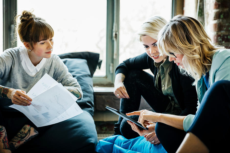 Businesswomen talking during an informal meeting Photograph by Hinterhaus Productions