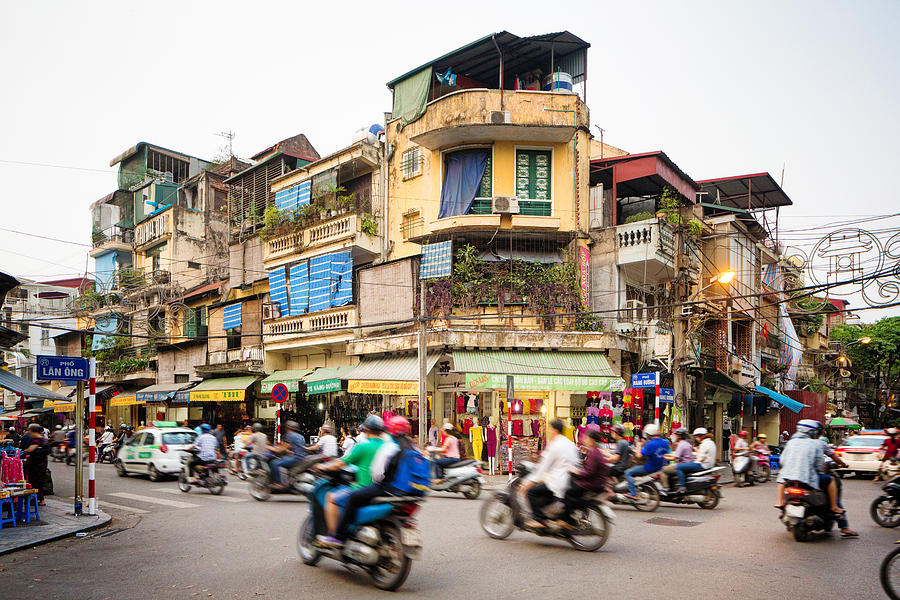Busy street corner in old town Hanoi Vietnam Photograph by NicolasMcComber