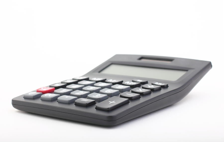 Calculator on a white background Photograph by Aslan Alphan