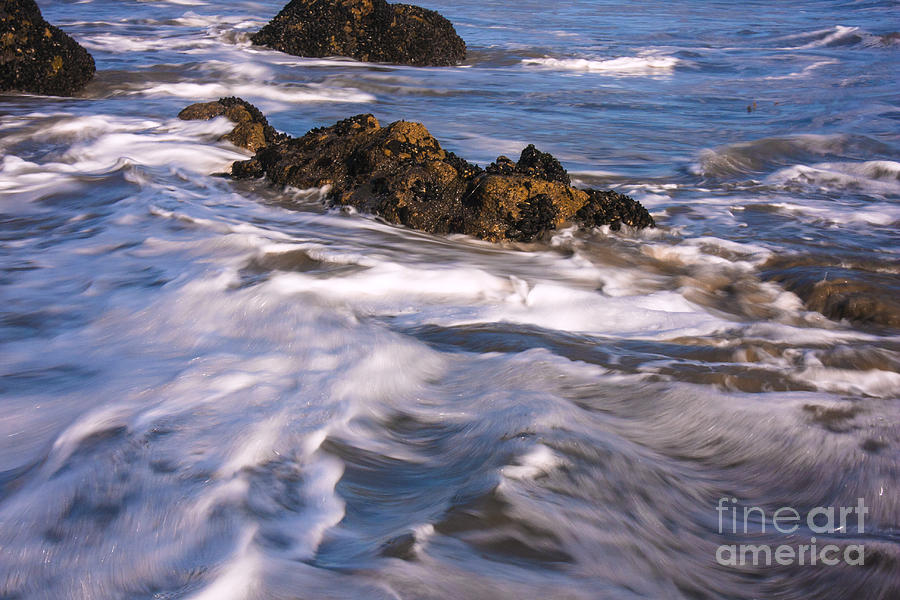 Calm Blue Ocean Waves Breaking Over The Rocks Photograph by Jerry Cowart