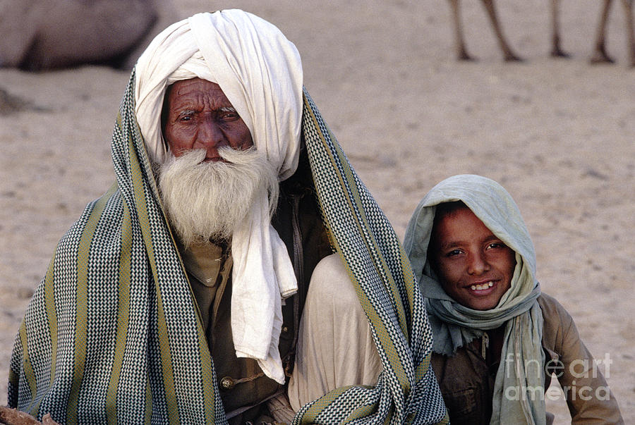 Camel Trader With Grandson - Pushkar Camel Fair Photograph by Craig Lovell