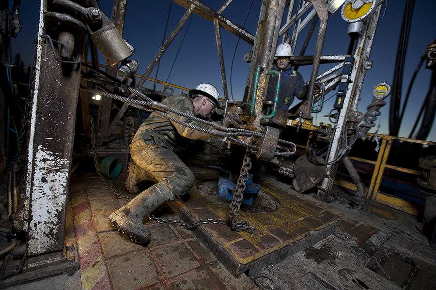 Canada, Alberta, Oil workers using oil drill Photograph by Tetra Images - Dan Bannister