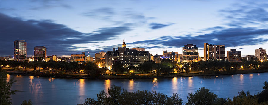 Canada, Saskatchewan, Saskatoon, Panoramic view of city and river at dusk Photograph by Henryk Sadura