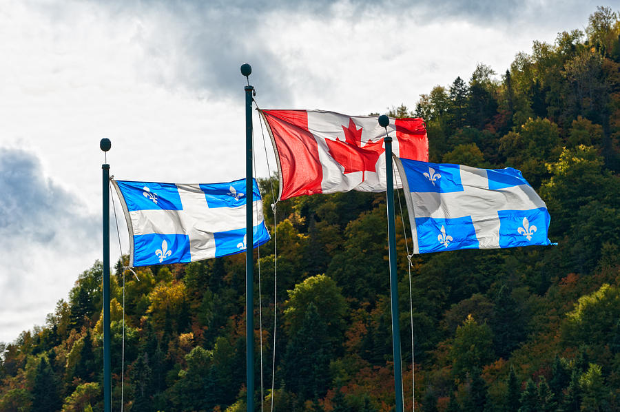 Canadian and the Quebec flag  Photograph by U Schade
