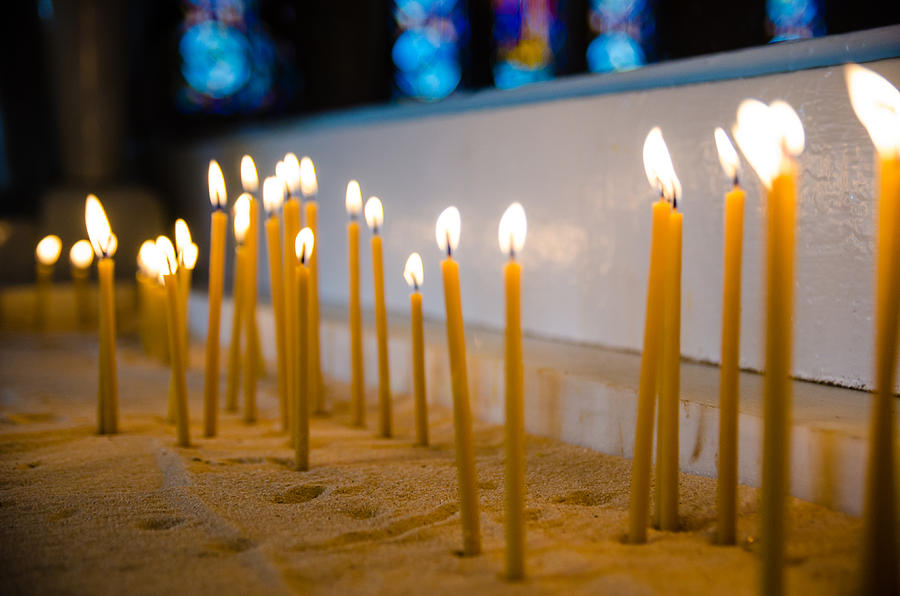 candles in the Catholic Church shallow depth of field Photograph by Alex Grichenko