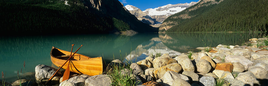 Banff National Park Photograph - Canoe At The Lakeside, Lake Louise by Panoramic Images