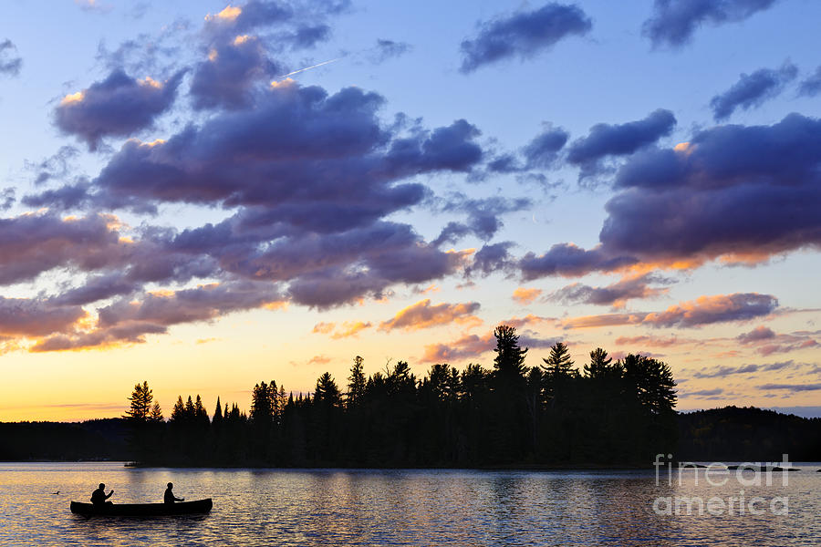 Canoeing at sunset Photograph by Elena Elisseeva