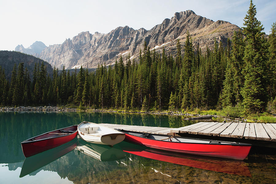 Canoes And Rowboat By A Dock On A Photograph By Michael Interisano 