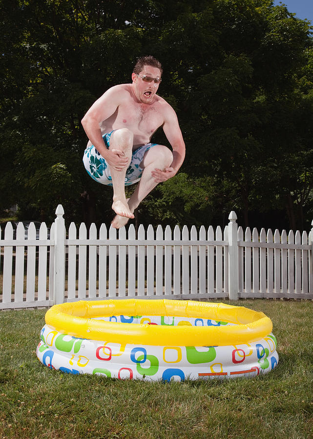 Canon ball into kiddie pool Photograph by PM Images