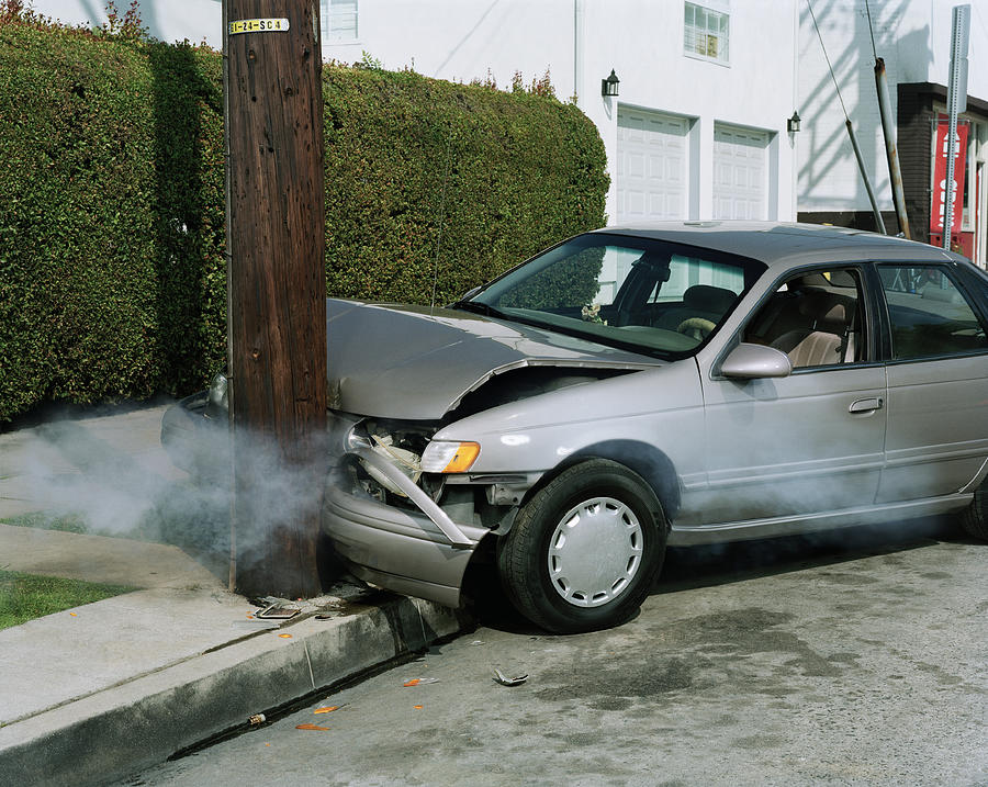 Car crash against telephone pole by road Photograph by Erik Von Weber