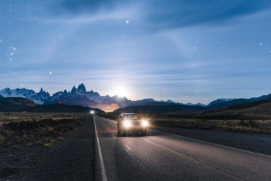 Car driving at night on the road to El Chalten, Patagonia Argentina Photograph by © Marco Bottigelli