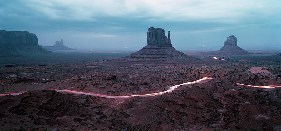 Nature Photograph - Car Trails By Mittens In Monument Valley by Gary Yeowell