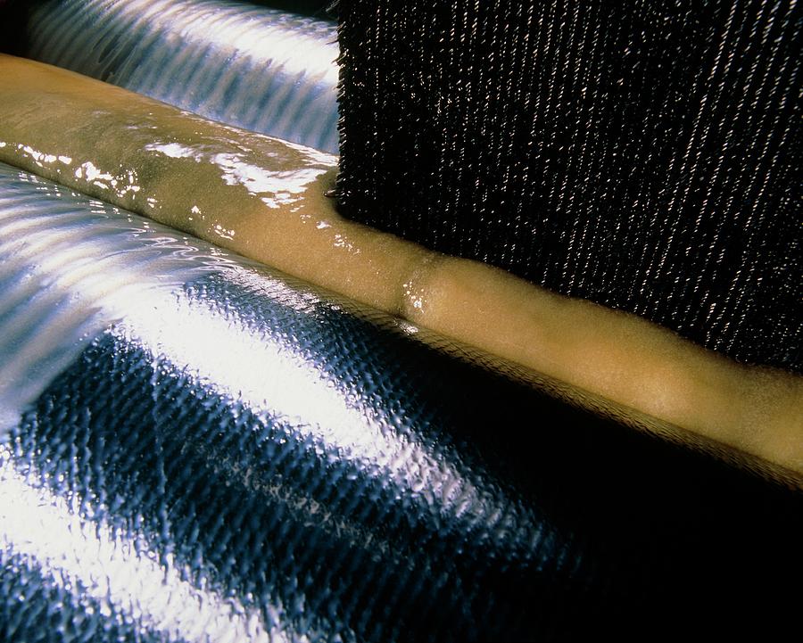 Carbon Fibre Fabric Being Impregnated With Resin by Tim Hazael/science  Photo Library
