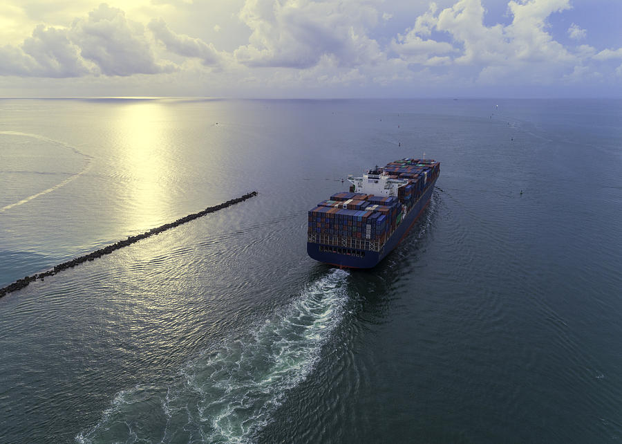 Cargo ship leaving port Photograph by Torresigner