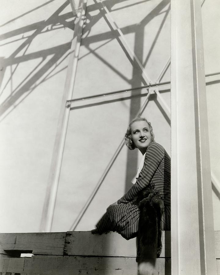 Carole Lombard Sitting On A Beam Of A Scaffolded Photograph by Cecil Beaton