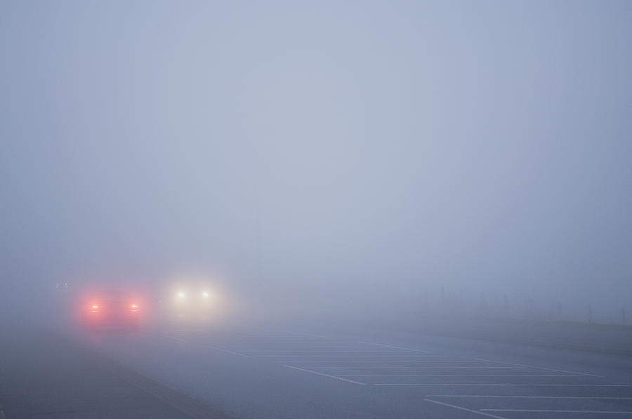 Cars driving in thick fog Photograph by Northlightimages