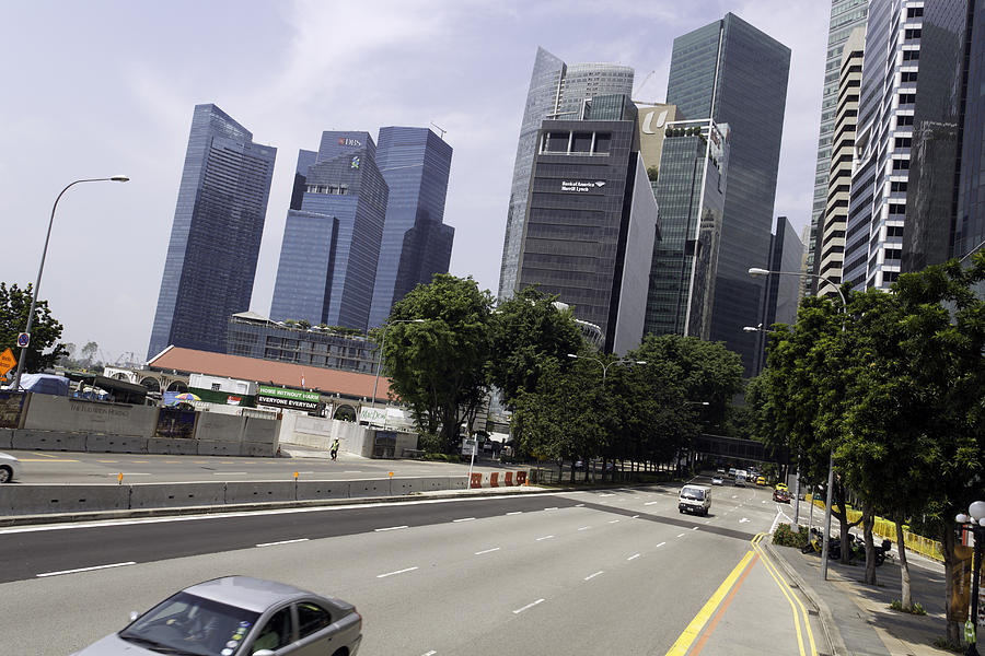 Cars on a street leading out from Financial District in Singapore - an angled view Photograph by Ashish Agarwal