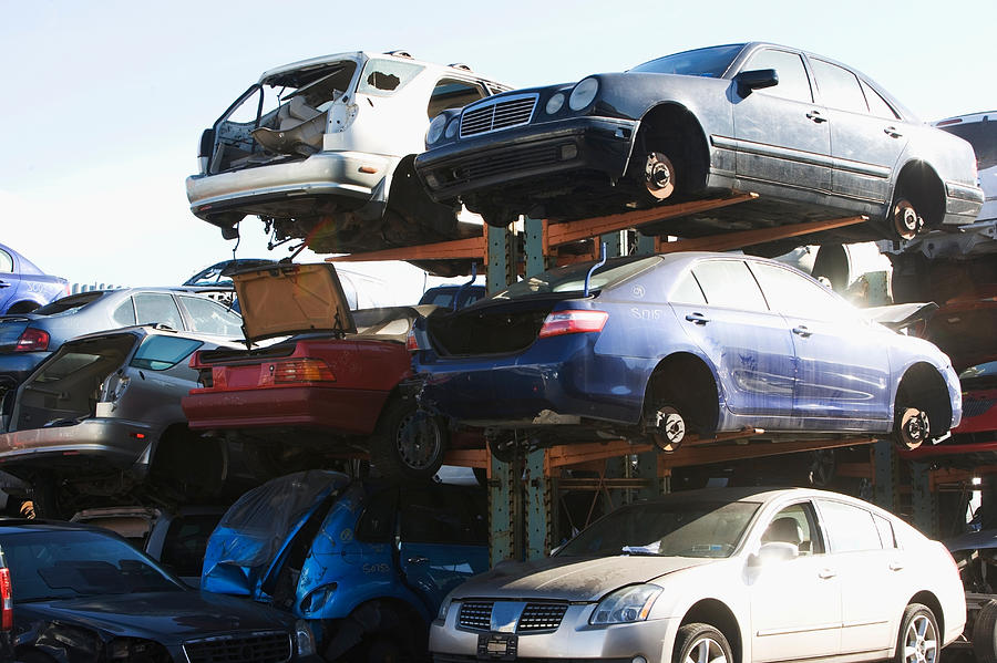 Cars sitting in junkyard Photograph by Image Source/Ditto